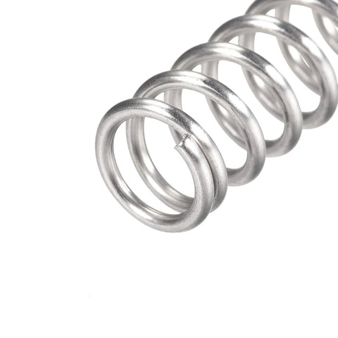 Close-up of uxcell compression spring, 304 stainless steel, 12 mm OD, 1.6 mm wire, silver, 10 pcs