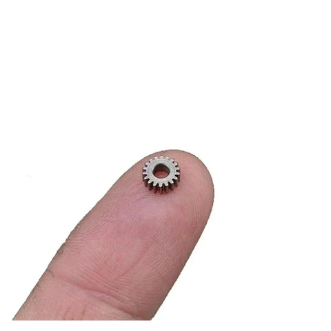 Close-up of a 0.3 Module Planetary Gearbox Gear, 5.95mm Diameter, 2.55mm Inner Hole Bore, on fingertip, 18 teeth for robotics and DIY projects.