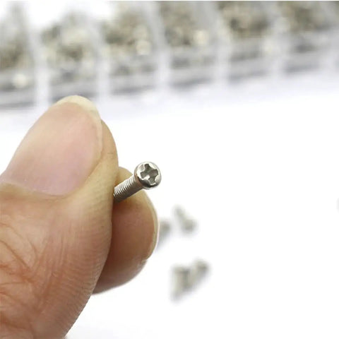 Hand holding silver screw from Miniature Screw Kit Set With Silver Tiny Screws For Eyeglasses, Sunglasses And Watches, Glasses Repair Tools