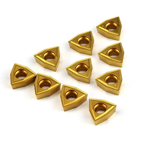 Ten gold WCMT2.52 55° diamond carbide turning inserts for CNC lathe and indexable tool holders, displayed on a white background.