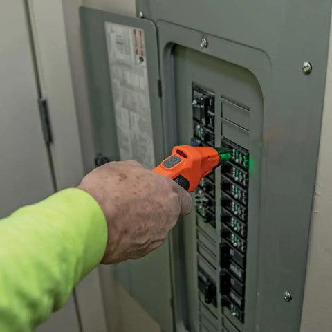 Person using Fast Circuit Breaker Finder Kit For Quick Panel ID And Safe Wiring, ET310 Receiver with GFCI tester on electrical panel.