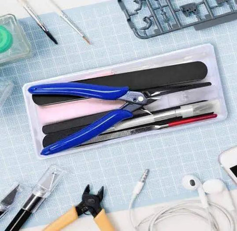 Pro Grade 13 Piece Plastic Model Tool Set with hobby clippers, tweezers, files, and knife on a gridded surface