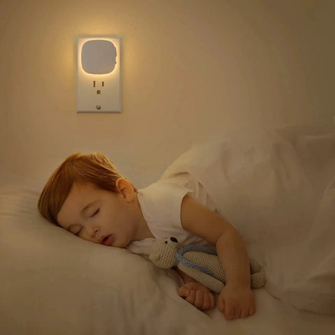 Child sleeping with Plug In Led Backlit Night Light With Motion Sensor Dusk To Dawn 1 To 50 Lm 4Pack installed on wall