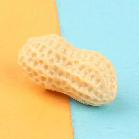 Close-up of single resin peanut from 15-Piece Realistic Miniature Nut Set For Dollhouses, Resin Nuts Including Walnut, Peanut And Pistachio.