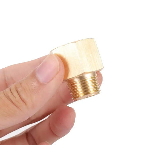 Brass Pipe Fitting Three Eighths Inch NPT Male To One Half Inch NPT Female Hex Head Bushing Adapter held in hand