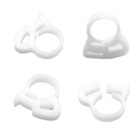 Four white snap grip plastic clamps from the Thirty Pcs Double Gripping Nylon Hose Clamps Designed For Three Eighth Inch Tubing set.
