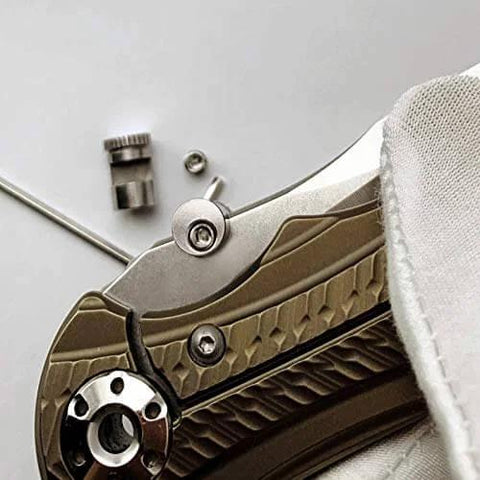 Close-up of knife with 3 Pack Thumb Stud Replacement For Buck 110 Knife With Hex Wrench in brass and stainless steel, showing installation.
