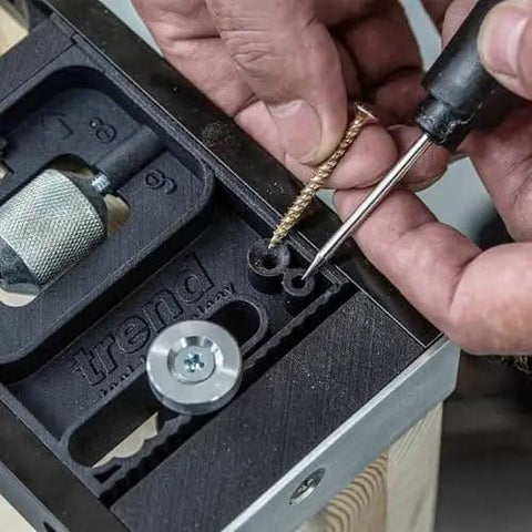 All-In-One Adjustable Door Hinge Jig Installation Kit For 2 Ft 6 In To 9 Ft Doors being adjusted with screwdriver