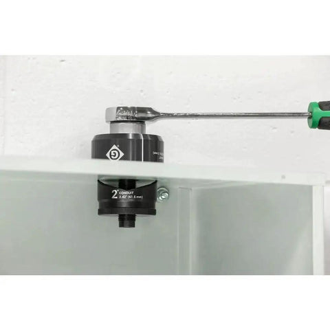 1 Inch Conduit Manual Knockout Set K3BB-1 in use with KRW-1 ratchet wrench on industrial panel