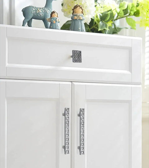 White cabinet with Crystal Glass Rhinestone Cabinet Pulls 4 Pack Shiny Dresser Knobs Handles for cupboard doors.