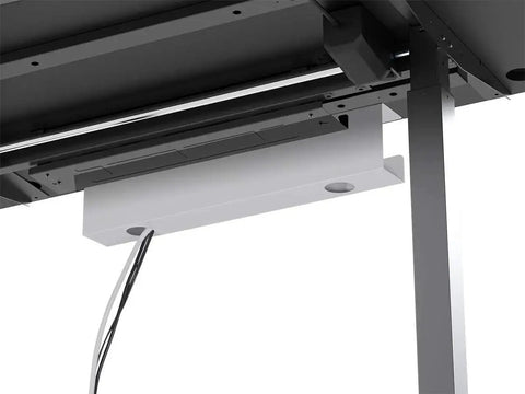 White under desk cable tray with steel wire management installed beneath a desk for organizing power strips and adapters.