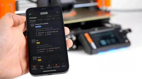 Person holding a smartphone showing the MK4S 3D Printer Kit With Automatic Calibration And Removable Sheets interface screen.