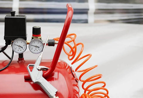 Red air compressor with hose, showcasing equipment for AirAid Air Tool Conditioner, Protective Coating, And Rust Inhibitor For Tools.