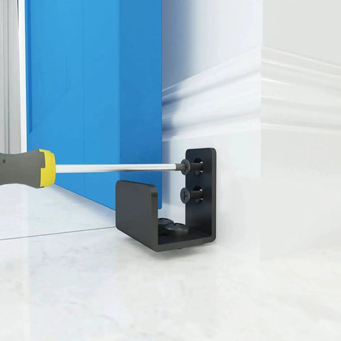Installed Matte Black Floor Guide Wall Mount For Sliding Barn Door Hardware Set Of 2, Adjustable For Door Thickness, close-up view.