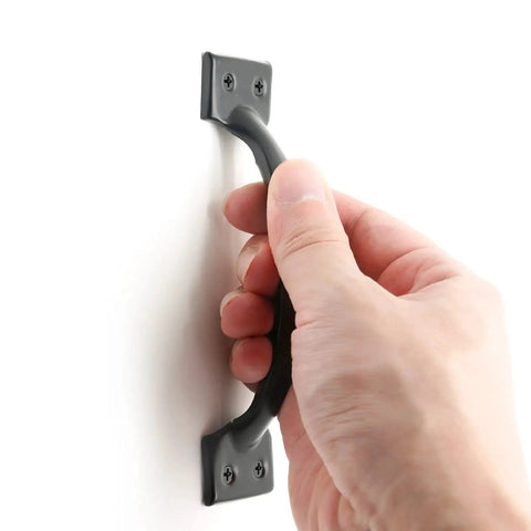 Hand holding Matte Black 4 Inch Cabinet Handle, showcasing durable hollow design for dressers and cupboards, 62mm center spacing.