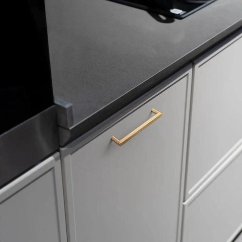5 Inch Champagne Bronze Cabinet Pull Handles 6 Pack With Grooved Texture And Non Slip Grip For Farmhouse And Industrial Cabinetry Decorative Hardware For Cabinets And Dressers, installed on a kitchen cabinet.