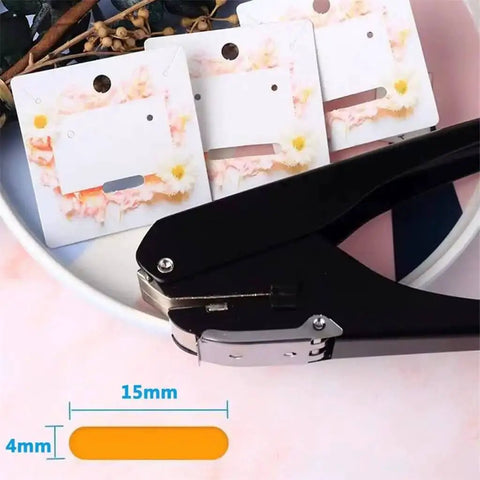 Oval Single Hole Punch 4 X 15mm Lever Action Steel Paper Puncher That Punches Up To 10 Sheets shown with punched cards