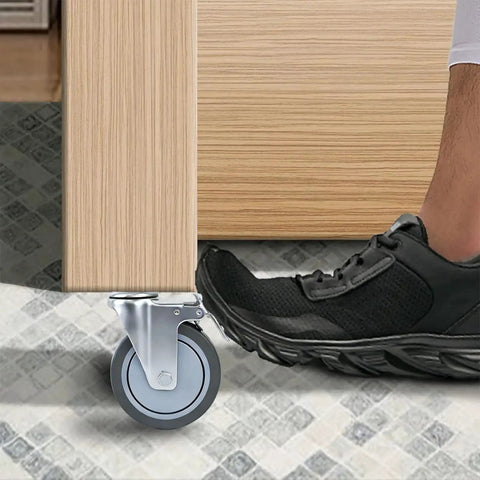Close-up of 5 Inch Locking Swivel Casters With Brake, 1/2-13 X 1.5 Threaded Stem, Grey TPR Rubber Wheels on furniture leg.
