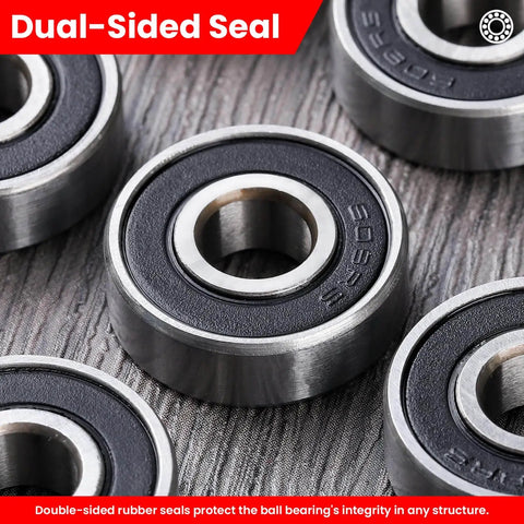Close-up of Pack of 12 608-2RS sealed ball bearings 8x22x7mm in steel with dual-sided rubber seals on textured surface.