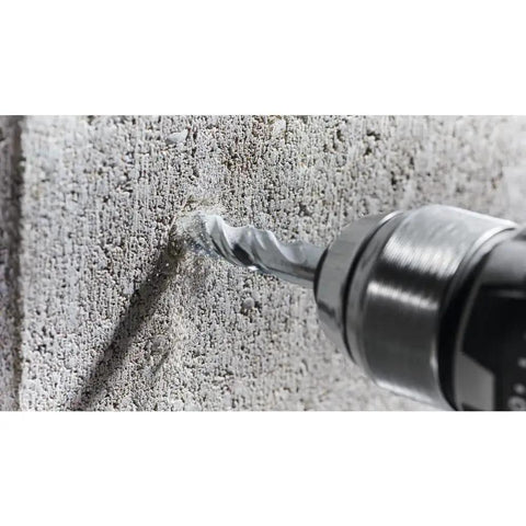 Fast Spiral Rotary Masonry Drill Bit With Carbide Head For Long Life And Quick Material Removal In Brick Block And Concrete Three Quarters Of An Inch By Four By Six Inches Bosch BM2019 drilling into concrete