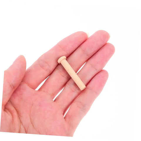 Miniature Wooden T Nails For Crafts And Woodworking With Ergonomic T Head Design shown in hand, emphasizing size and beige color.