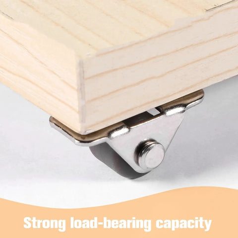 Close-up of silver Mini Half Inch Fixed Caster with Metal Top Plate installed on wooden furniture, quiet rubber wheel visible.