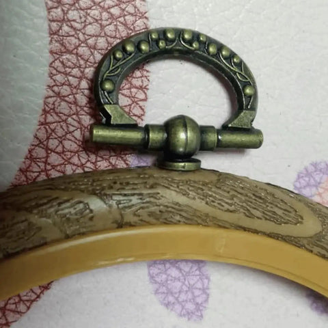 Close-up of antique bronze finish knob from Mini Cabinet Knob Set Ten Pack with self tapping screws for furniture hardware, size 24x27mm.