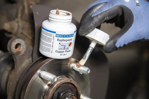 Copper Paste Anti Seize Lubricant For High Temperature Threads And Joints being applied to a brake component
