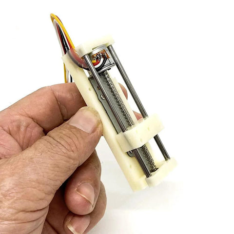 Hand holding Compact 5V Micro 2 Phase 4 Wire Stepper Motor Linear Rail Actuator With 48mm Stroke 18 Degree Step Angle