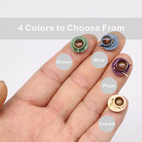 Whimsical Tiny Magnetic Tea Cup Decor Set For Doors in green, blue, plum, and cream colors displayed on a hand