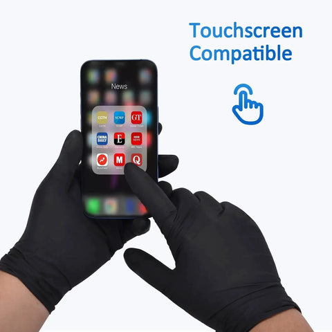 Person wearing black nitrile exam gloves using a smartphone, text reads 'Touchscreen Compatible', medium size, 100-count box.