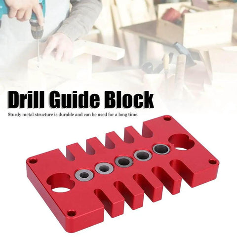 3-In-1 Dowel Jig Drill Guide Block for Woodworking, red aluminum alloy, used on workbench with tools in background