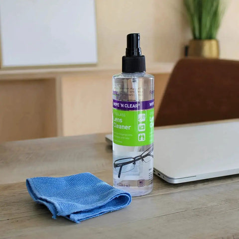 Streak Free Eyewear Screen And Lens Cleaner Spray for glasses and cameras on desk with blue cloth