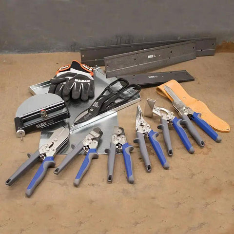 Assorted sheet metal tools including V Notcher For Ductwork And Sheet Metal Cutter For 30 Degree V Angles and other accessories on concrete floor
