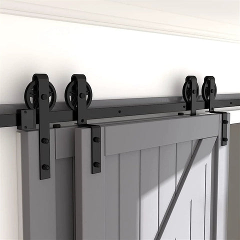 Hard Wearing Sliding Barn Door Track Hardware Kit For Tight Spaces Black Powder Coated 6mm Carbon Steel With Ultra Quiet Rollers And Bypass Option, Library Ladder Style, Fits Single Or Double Wooden Doors In Low Ceiling Areas installed on a grey door.