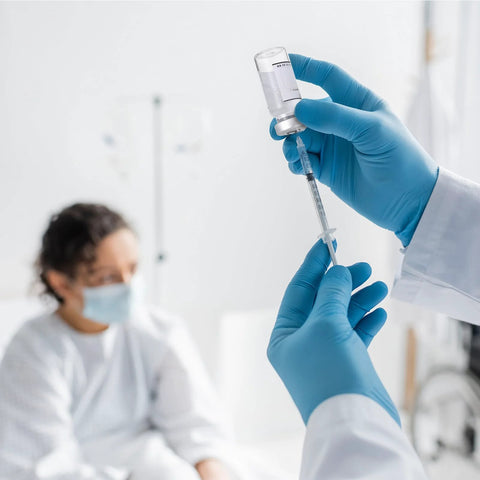 Threlaco 10ml sterile glass vials; syringe drawn by blue-gloved hands in a clinical lab.