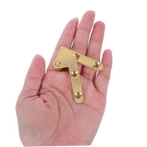 Heavy Duty Hidden Door Pivot Hinges Copper Rotating Hinge Set Two Pack held in hand for size reference, ideal for wood secret doors.