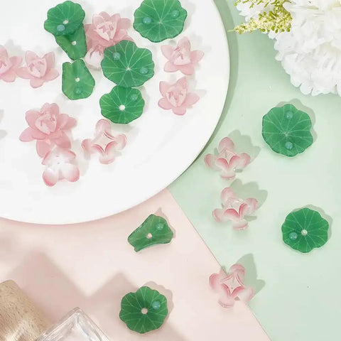 Dope Lotus Acrylic Beads Set, 24 Pieces In 7 Styles, 10-30mm Mini Flower And Leaf Beads for jewelry making displayed on a table