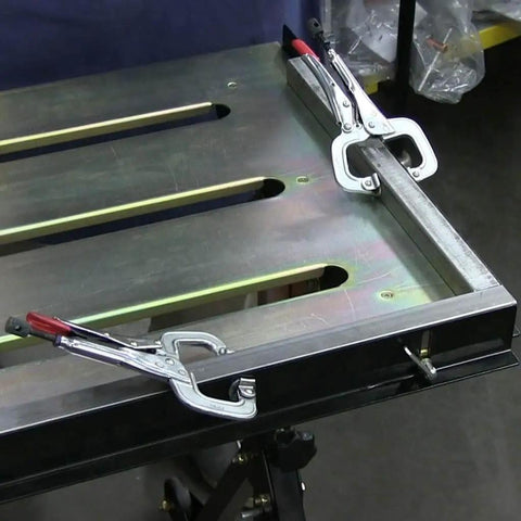 Worksite Ready Welding Table Pro Grade With 1.1 Inch Slot Top Adjustable Height And Tilt Casters For Easy Mobility Retractable Guide Rails Eccentric Leveling Feet Three Position Angled Tabletop For Horizontal 30 Degree Or Folded Storage Use, close-up view of slot top with clamps