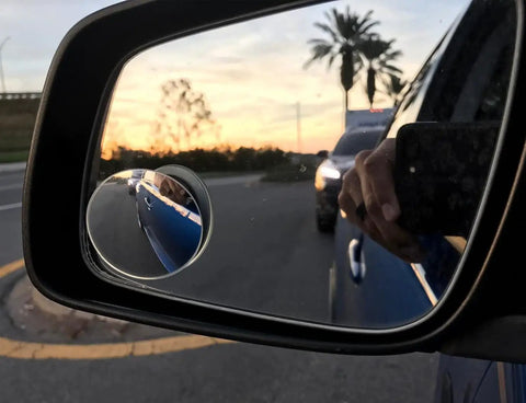 Blind Spot Mirror 2 Inch Round HD Glass Frameless Convex Rear View Mirror Pack Of 2 For Side Mirrors No-Fuss 360 Degree Adjustable Clear Wide Angle Easy Install attached to side mirror showing clear reflection of surroundings.