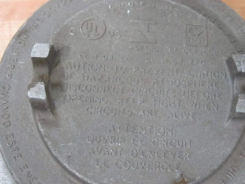 Close-up of the lid for Explosion Proof Junction Box C Style 2 Inch Hub GUAC69, metal box with safety markings, UL Listed and CSA Certified.
