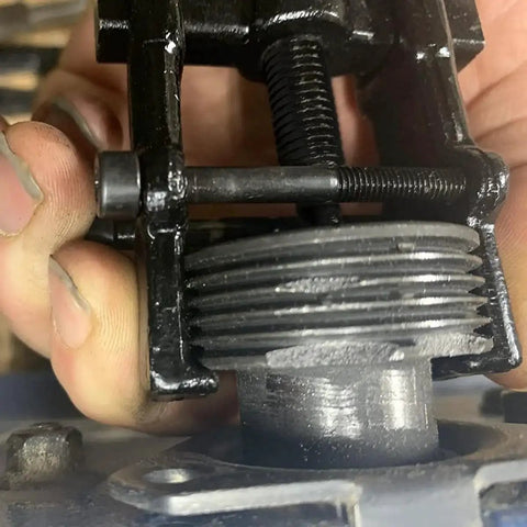 Close-up of 3 Inch Two Jaw Gear Puller With Adjustable CR V Steel For Bearings And Pulleys in use on machinery part.