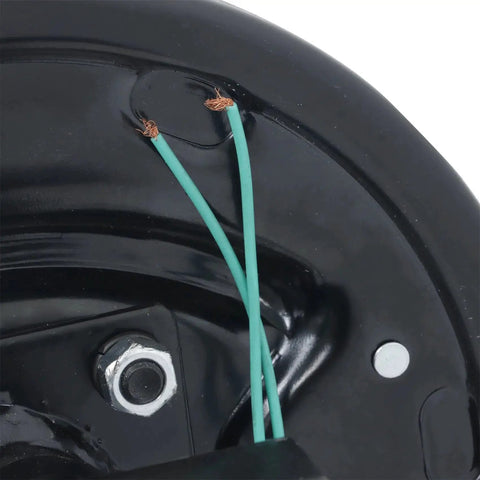 Close-up of black trailer axle end for an electric brake setup, showing green wires and a silver mounting bolt.