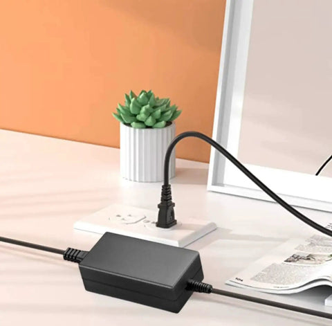 24V AC DC Power Adapter Replacement For MW GST60A24 GST60A24P1J Mean Well 24VDC 2.5A 60W on desk with power outlet
