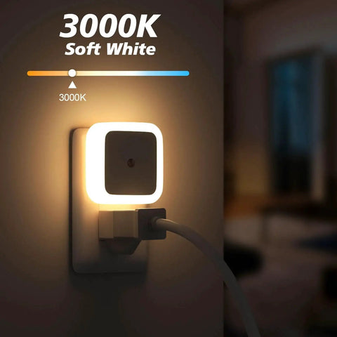 Close-up of a 3000K warm white LED from 8 Pack Dusk To Dawn Wall Plug Night Lights, installed in an outlet, glowing softly.