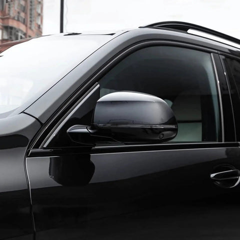 Close-up of a black car's side mirror, glossy finish using Crystal High Gloss Auto Clear Coat Pen 1.5 Oz For Cars Touch Up And Peel Repair