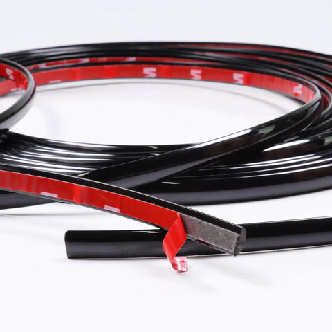 Glossy Black 12mm Automotive Trim Molding 25 Foot Self Adhesive for Vehicles showing red adhesive backing and flexibility