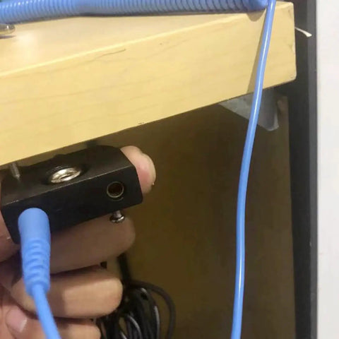 Connecting Essential ESD Grounding Kit to workbench, showing blue dual 4mm copper ground cords and anti-static setup for equipment protection.