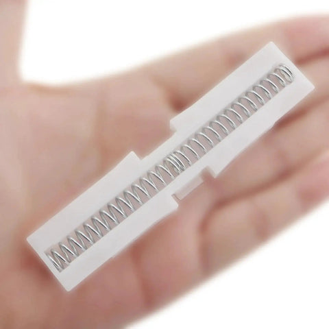 Two Piece White ABS Sliding Guide Rails Kit For Double Folding Doors Top Track Hardware in hand, showcasing spring mechanism.