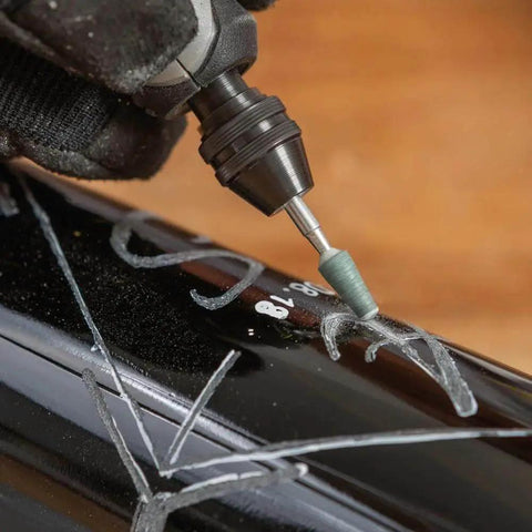 Versatile 11 Piece Carving And Engraving Micro Accessory Kit For Dremel Rotary Tools in use on black metal surface